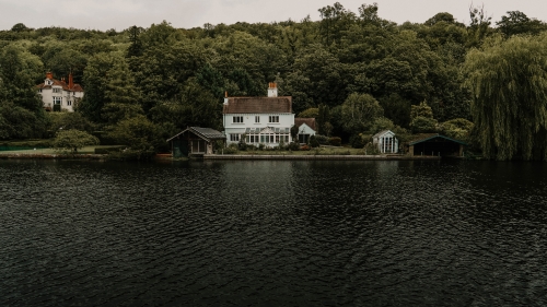 Beautiful Lake and Green Forest with Big House on Shore