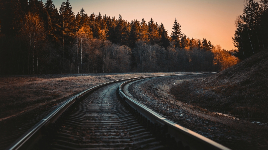 Beautiful Railroad in Spruce Forest and Sunset