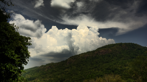 Green Hill and Clouds in Sky