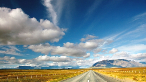 Road in Desert and Clouds in Sky